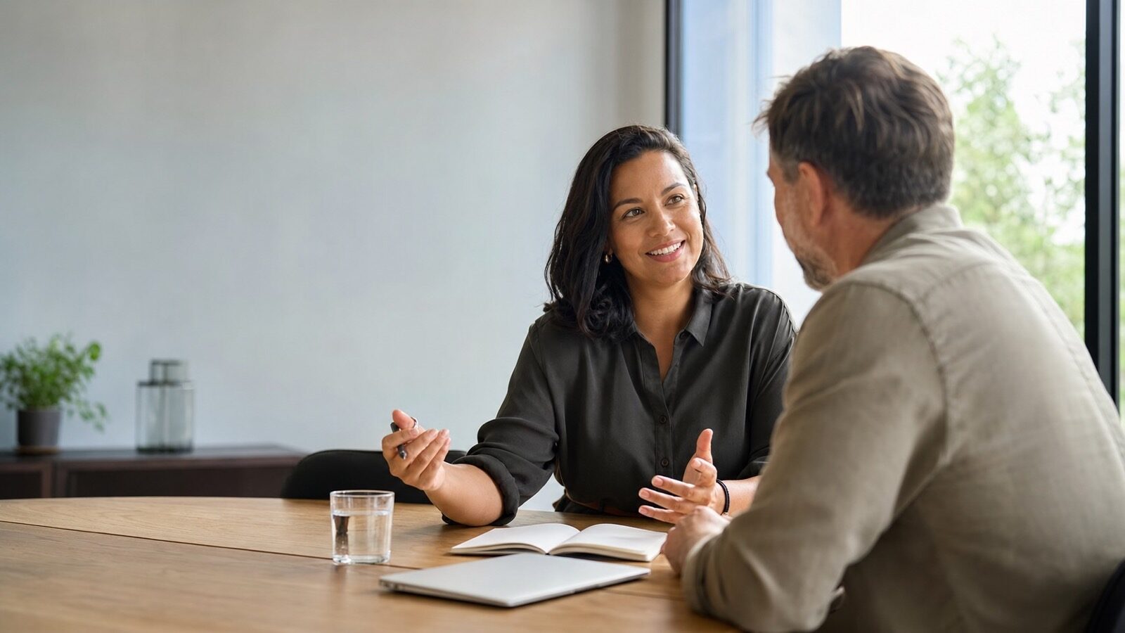 A New Zealand business development professional meeting a client across a table